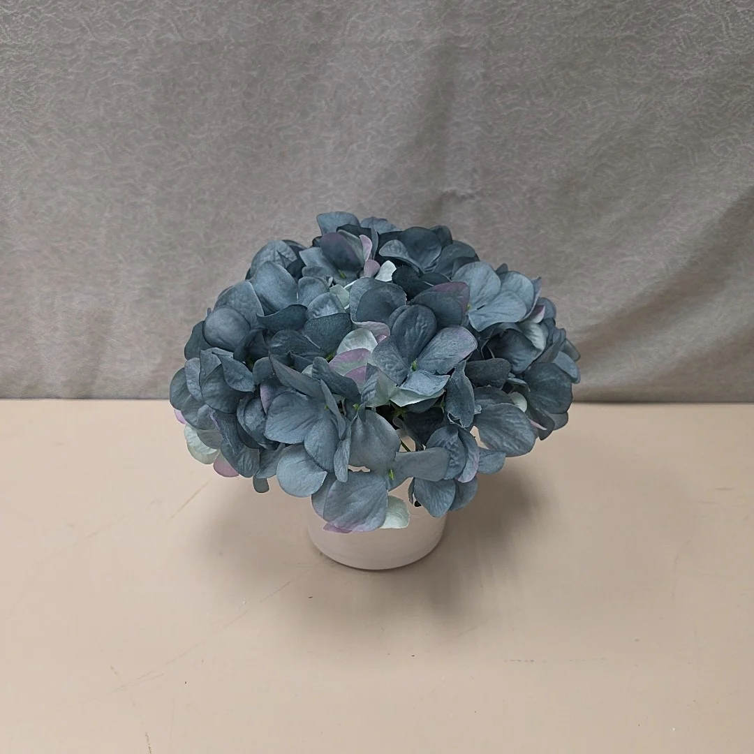 BLUE FLOWERS IN WHITE VASE