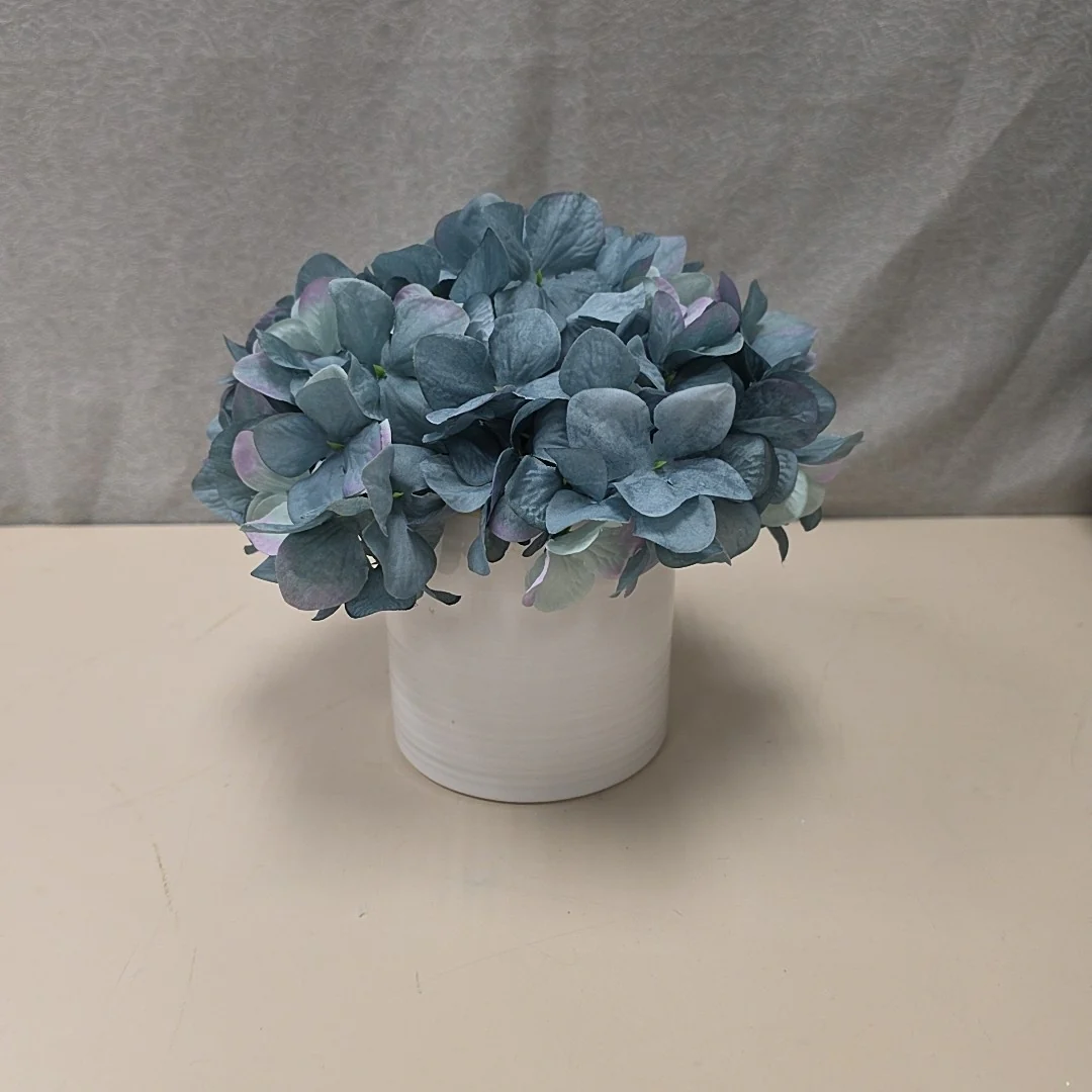 BLUE FLOWERS IN WHITE VASE