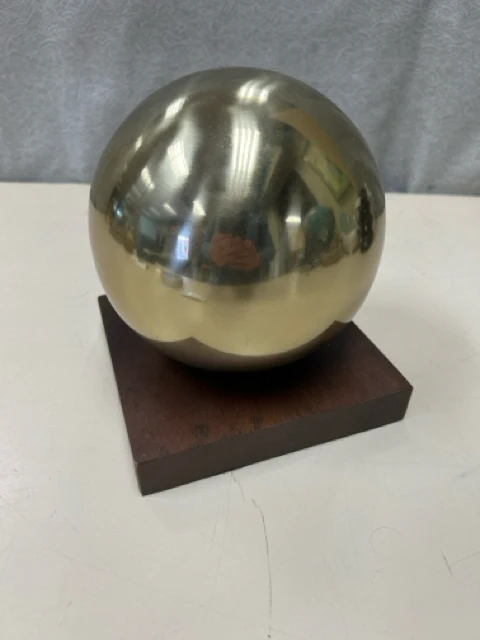 GOLD SPHERE ON WOOD STAND
