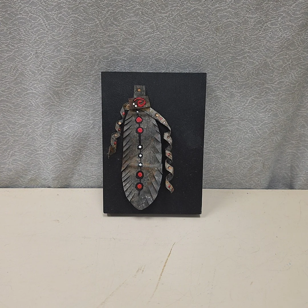 TIN FEATHER ON WOOD